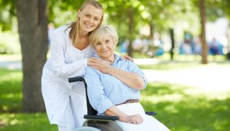 nurse caring for elderly lady in wheelchair
