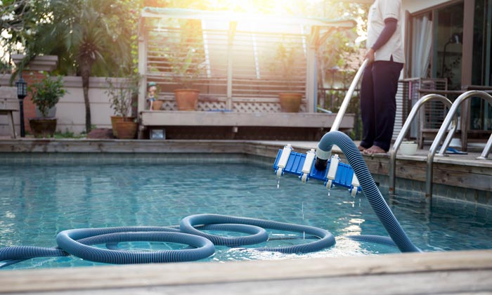 vacuuming storm debris from swimming pool